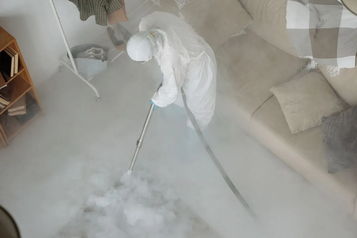 Biohazard cleanup technician in protective equipment, New Sharon, IA
